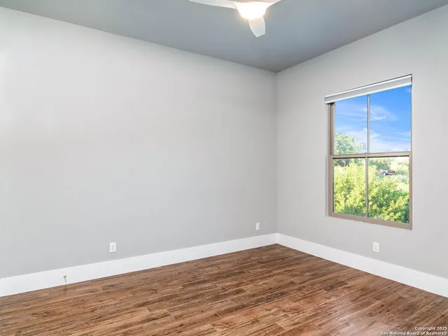 a front view of a house with a yard and potted plants