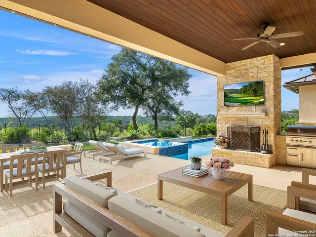an aerial view of residential houses with outdoor space and swimming pool