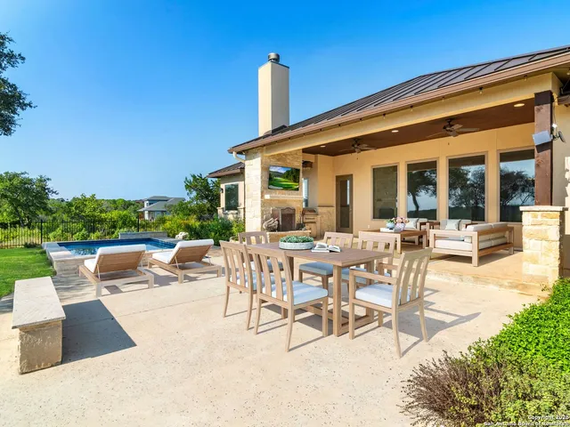 an aerial view of residential houses with outdoor space and trees