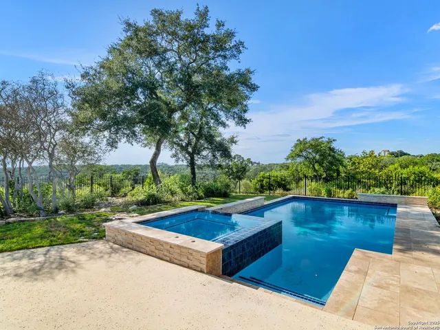 an aerial view of a house with a yard and garden