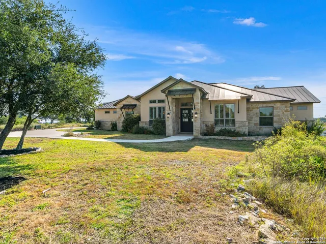 a view of a dining room with furniture and a chandelier