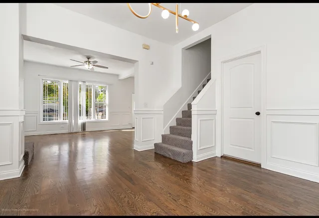 a view of an entryway with wooden floor