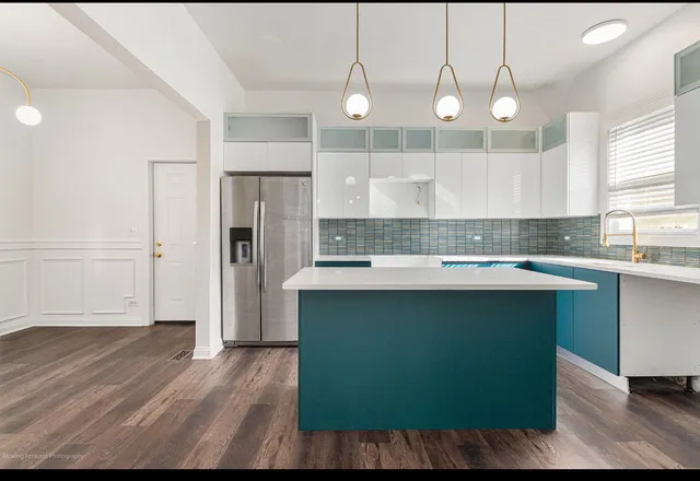 a view of a kitchen with wooden floor and a sink