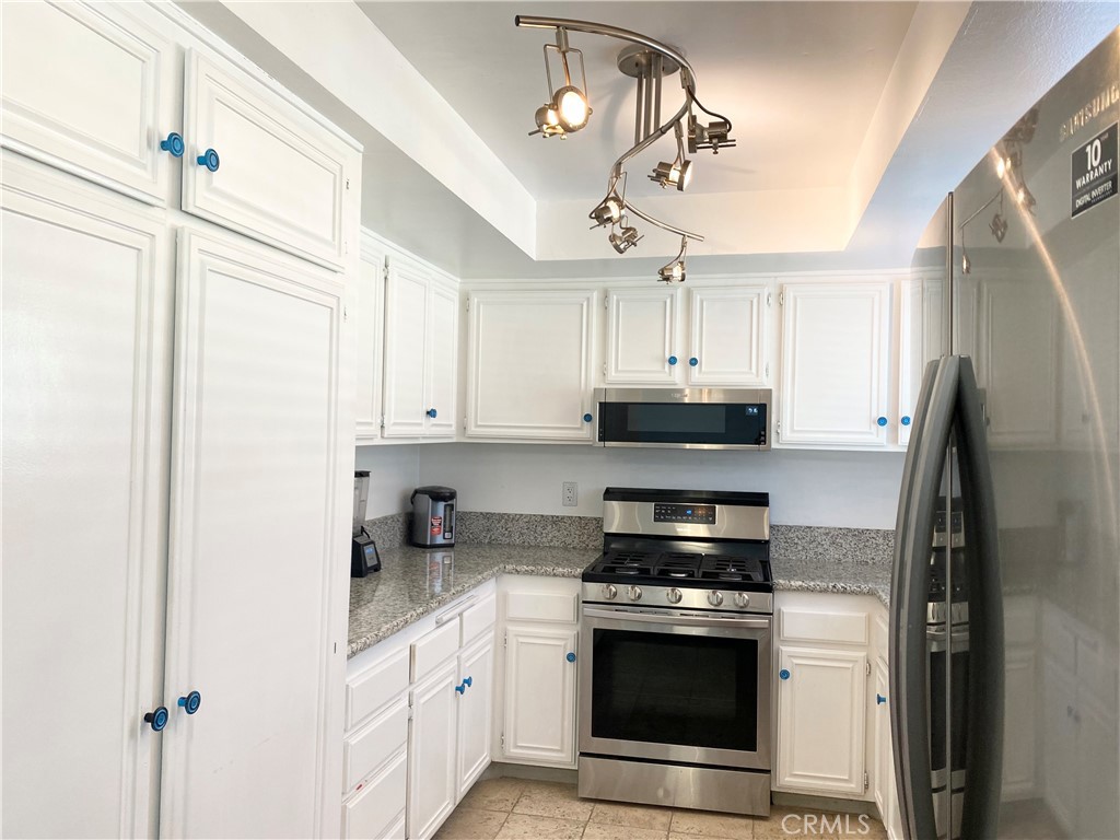 1450 West 146th Street, Unit 2 Gardena, CA 90247 - Photo 13 of 33 a kitchen with stainless steel appliances a stove a refrigerator and a sink