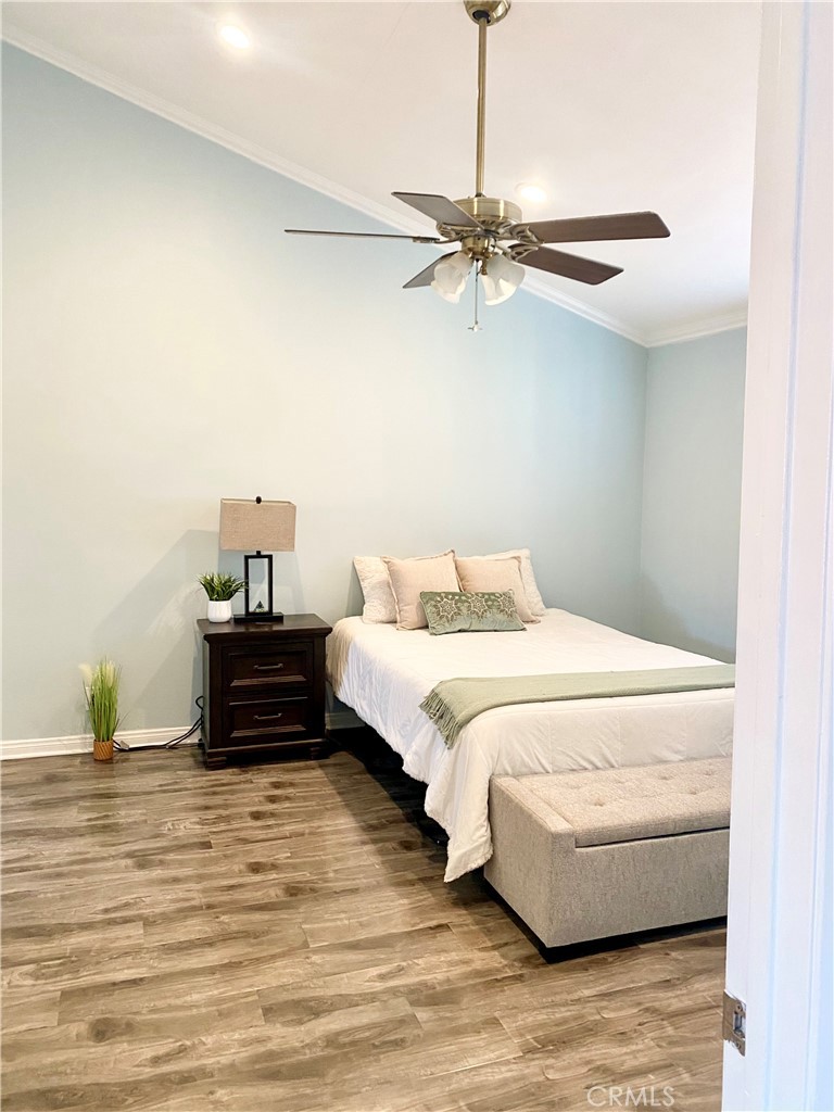 1450 West 146th Street, Unit 2 Gardena, CA 90247 - Photo 19 of 33 a bedroom with a bed and wooden floor