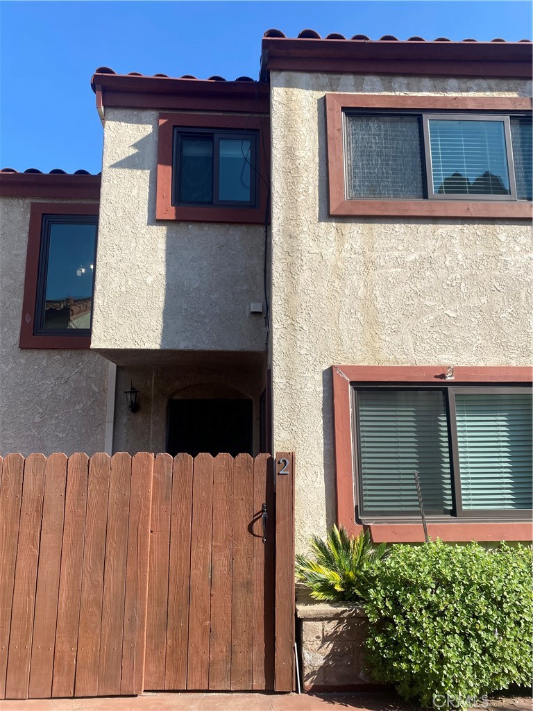 1450 West 146th Street, Unit 2 Gardena, CA 90247 - Photo 2 of 33 a front view of a house with large windows