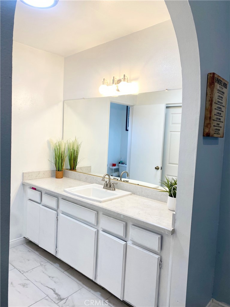 1450 West 146th Street, Unit 2 Gardena, CA 90247 - Photo 23 of 33 a bathroom with a sink and a mirror