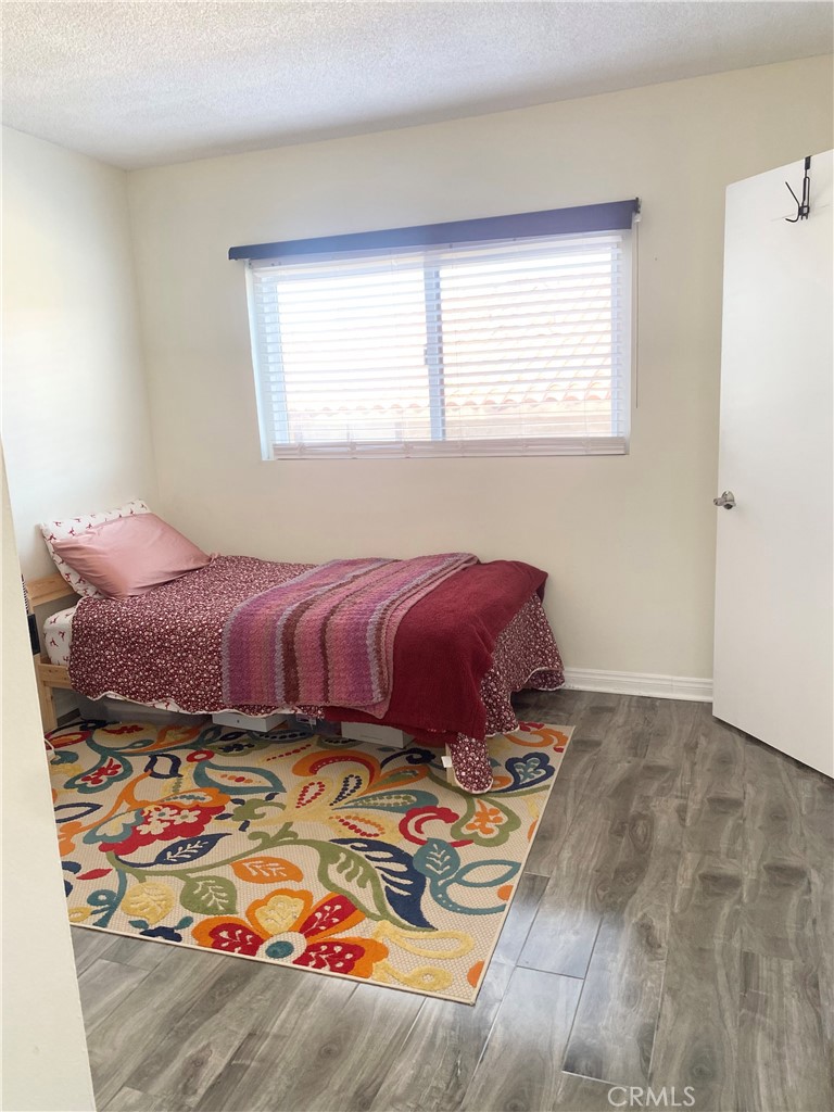 1450 West 146th Street, Unit 2 Gardena, CA 90247 - Photo 25 of 33 a bed sitting in a bedroom next to a window