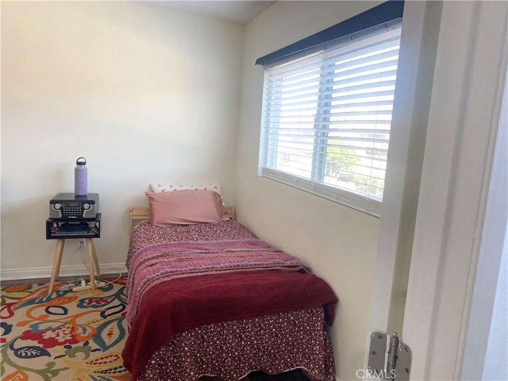 1450 West 146th Street, Unit 2 Gardena, CA 90247 - Photo 26 of 33 a bedroom with a bed and a lamp on the dresser