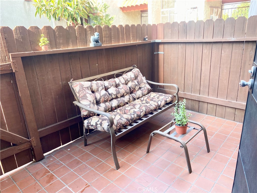 1450 West 146th Street, Unit 2 Gardena, CA 90247 - Photo 30 of 33 a balcony with table and chairs