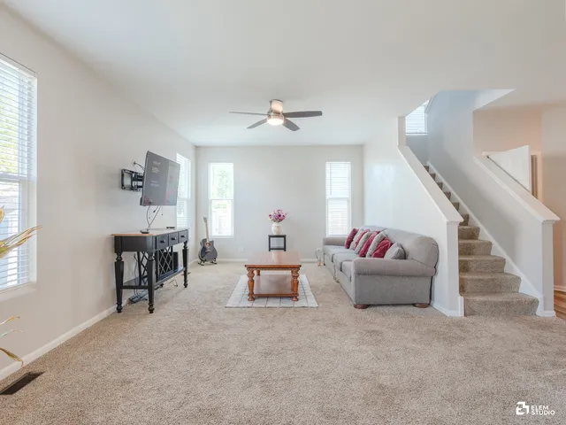a living room with furniture and white walls