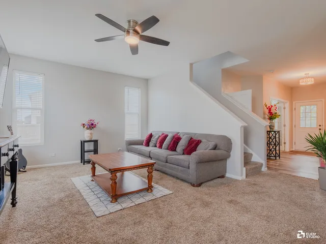 a living room with furniture and a chandelier