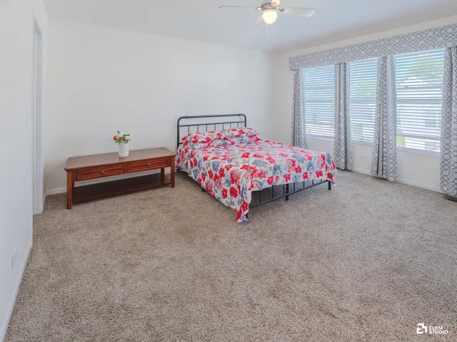 a bed sitting in a bedroom next to a window