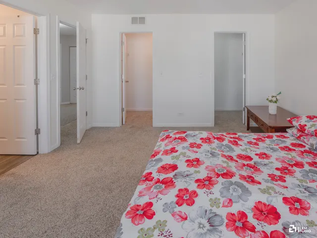 a bedroom with a bed and a dresser