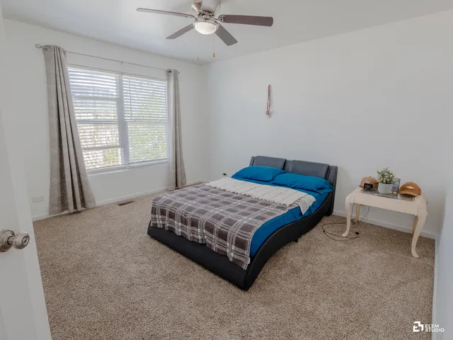 a bedroom with a bed and window