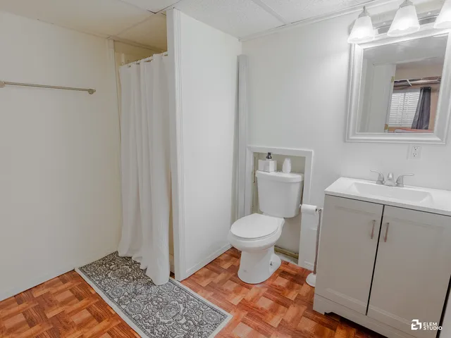 a bathroom with a toilet a sink a vanity and mirror