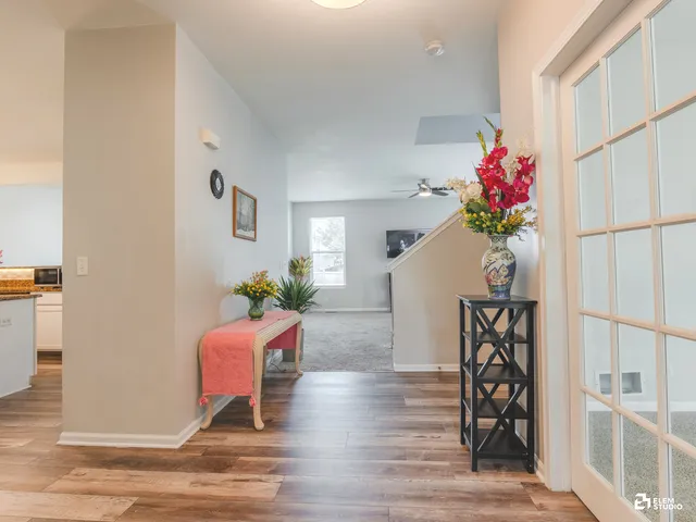a living room with furniture and flowers