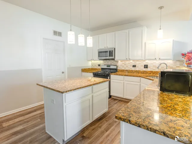 a kitchen with a sink stove and cabinets