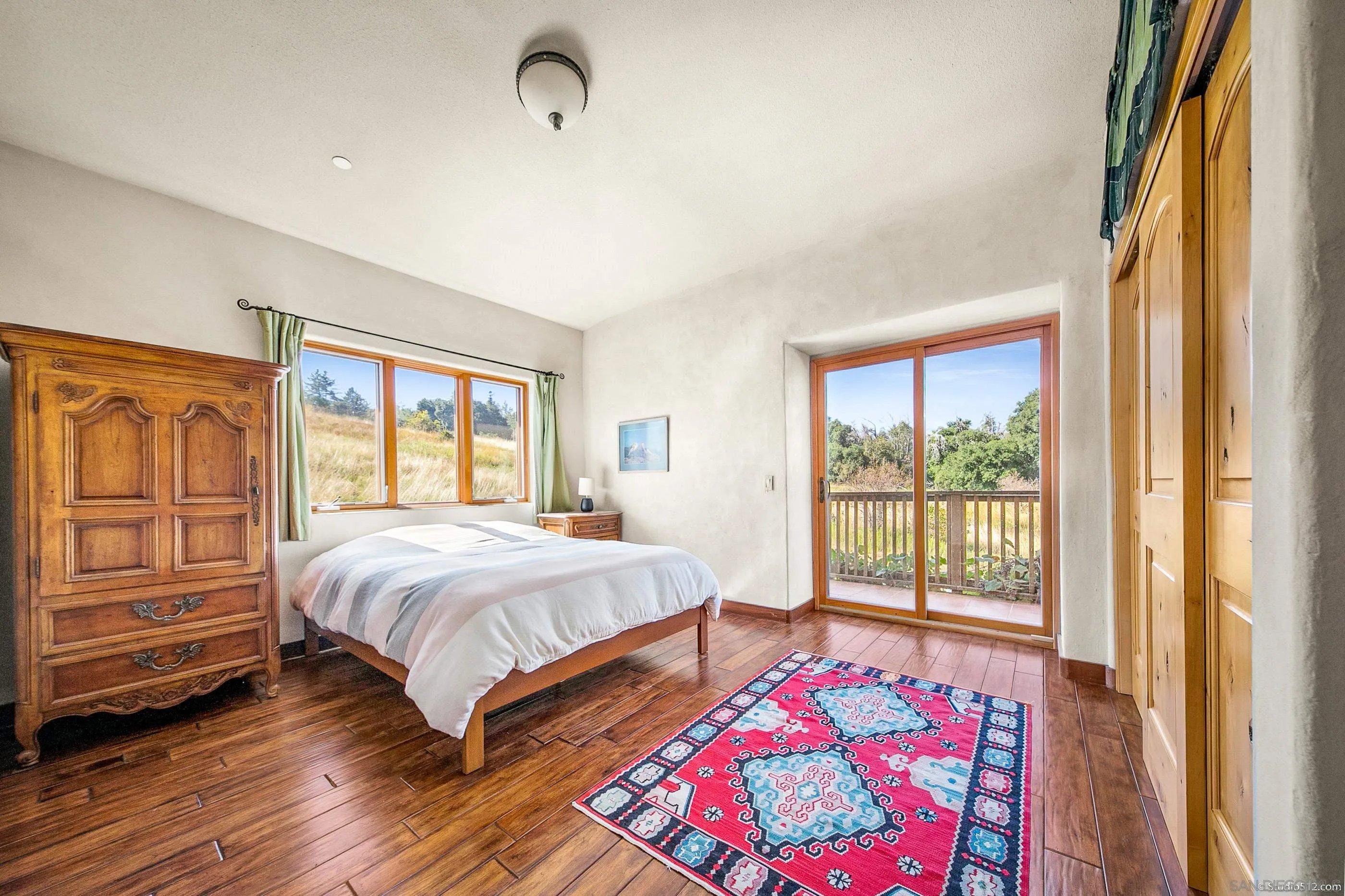 1861 Wynola Road Julian, CA 92036 - Photo 40 of 75 a bedroom with a bed and wooden floor