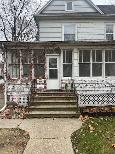 a view of a house with a bench in a yard