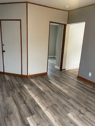 a view of a room with wooden floor