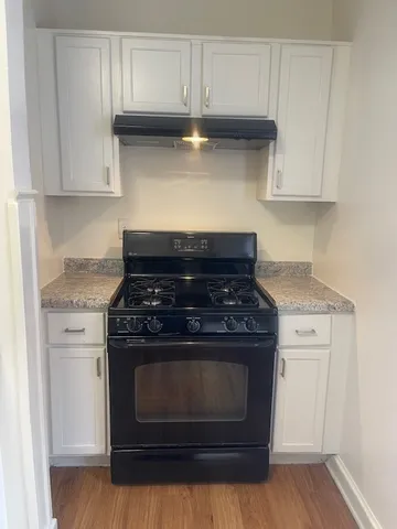 a stove top oven sitting inside of a kitchen