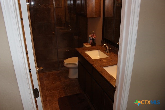 3009 Lenora Drive Victoria, TX 77901 - Photo 11 of 25 a bathroom with a granite countertop sink toilet and shower