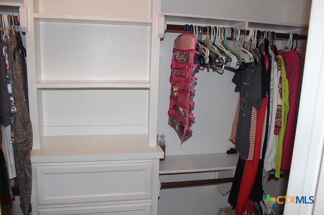 3009 Lenora Drive Victoria, TX 77901 - Photo 14 of 25 a view of walk in closet with clothes and shoes