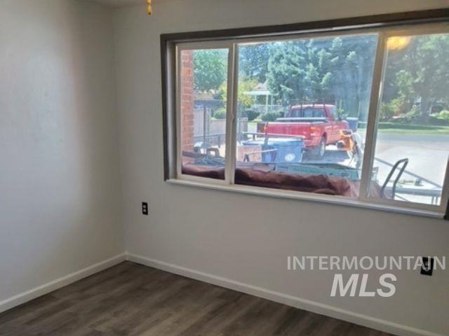 817 Union Avenue Filer, ID 83328 - Photo 18 of 37 Empty room with baseboards and dark wood-style flooring