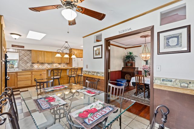 1S225 Valley Road Lombard, IL 60148 - Photo 12 of 46 a living room with furniture dining table and a view of kitchen