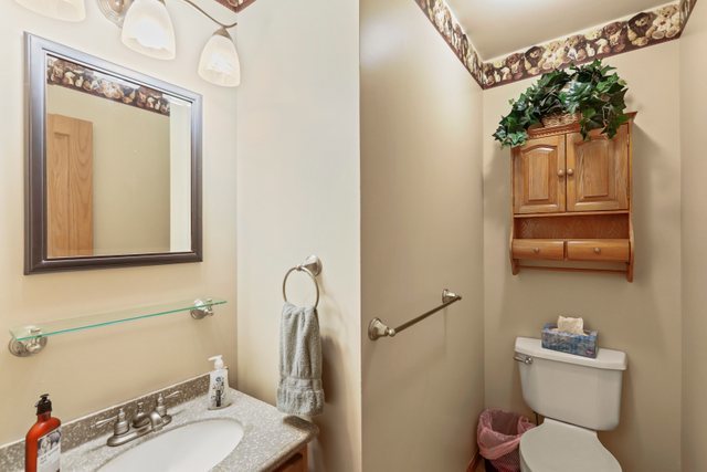 1S225 Valley Road Lombard, IL 60148 - Photo 13 of 46 a bathroom with a toilet sink and mirror