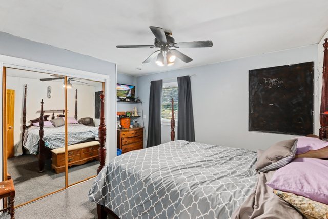 1S225 Valley Road Lombard, IL 60148 - Photo 14 of 46 a bedroom with a bed and a walk in closet