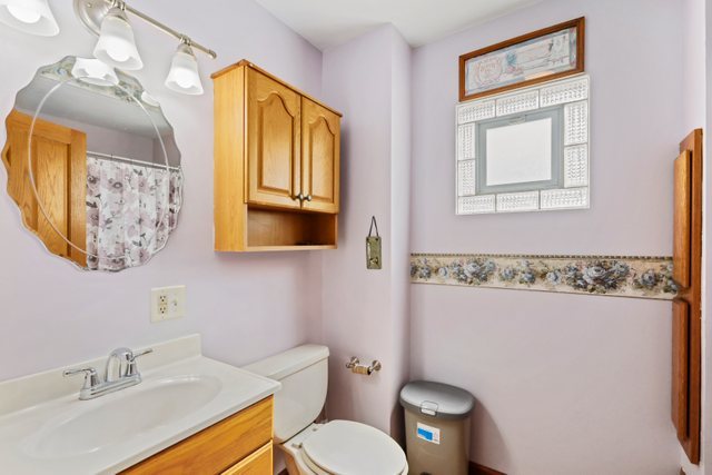 1S225 Valley Road Lombard, IL 60148 - Photo 16 of 46 a bathroom with a toilet sink and mirror