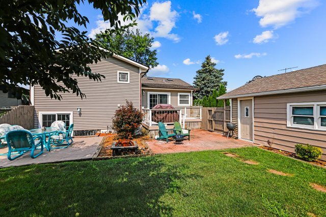 1S225 Valley Road Lombard, IL 60148 - Photo 37 of 46 a backyard of a house with table and chairs with wooden fence and plants