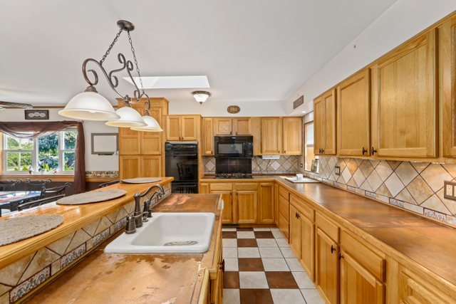 1S225 Valley Road Lombard, IL 60148 - Photo 10 of 46 a kitchen with stainless steel appliances granite countertop a sink and cabinets