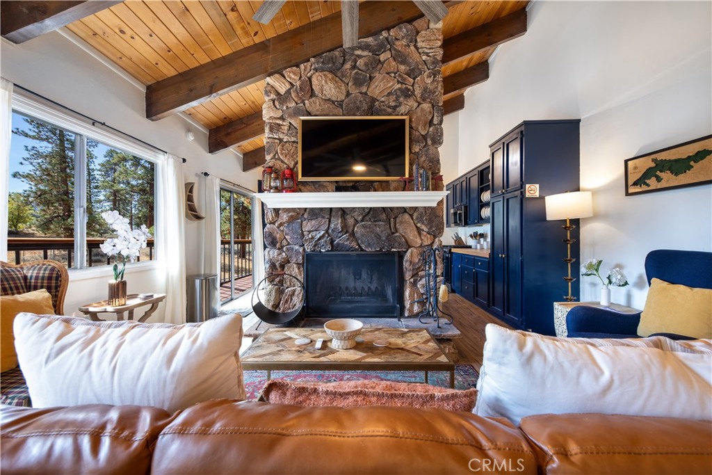 39651 Flicker Road Fawnskin, CA 92333 - Photo 11 of 58 a living room with furniture a fireplace and a large window