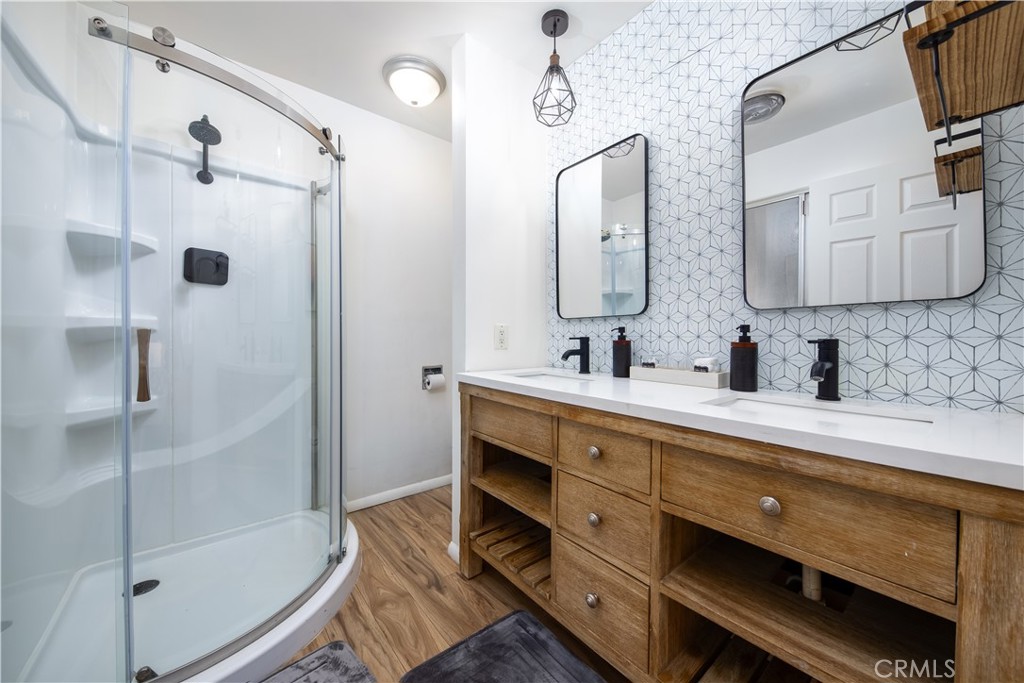39651 Flicker Road Fawnskin, CA 92333 - Photo 19 of 58 a bathroom with a double vanity sink mirror and shower