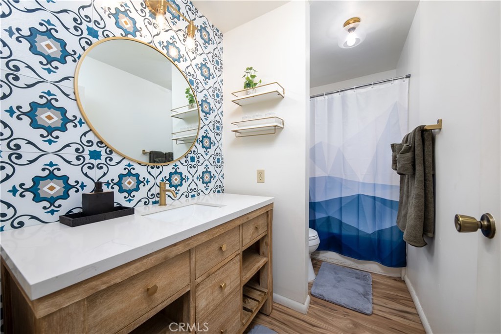 39651 Flicker Road Fawnskin, CA 92333 - Photo 21 of 58 a bathroom with a sink a mirror and shower