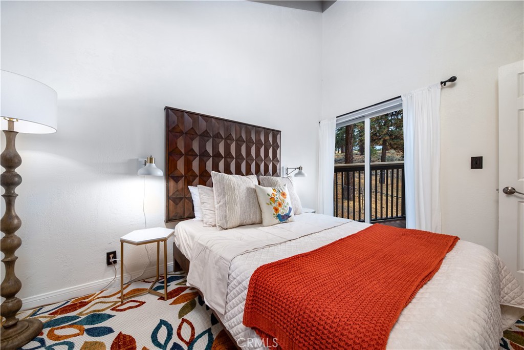 39651 Flicker Road Fawnskin, CA 92333 - Photo 23 of 58 a bedroom with a bed and wooden floor