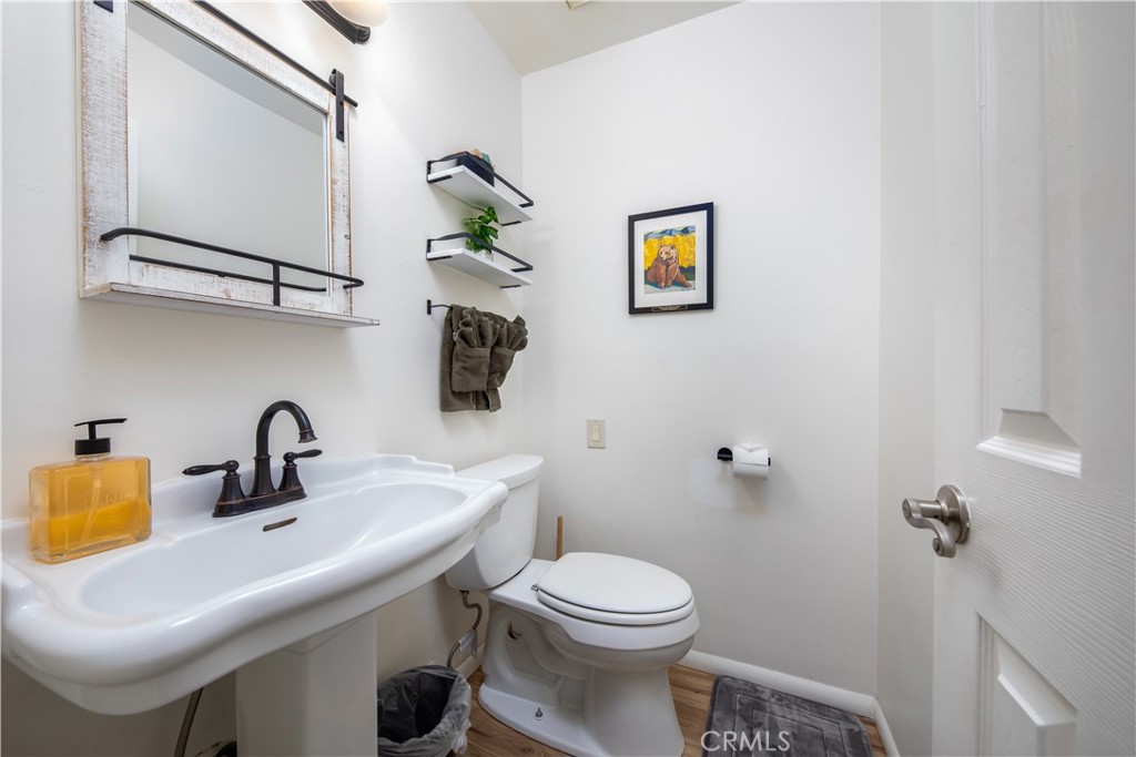 39651 Flicker Road Fawnskin, CA 92333 - Photo 24 of 58 a bathroom with a sink mirror and toilet