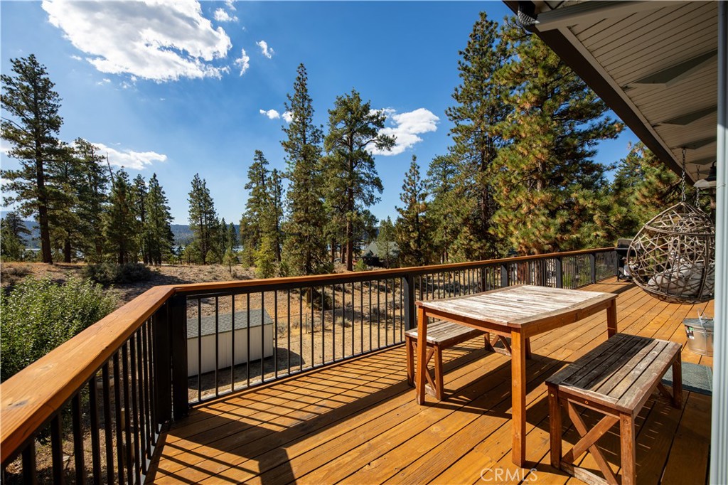 39651 Flicker Road Fawnskin, CA 92333 - Photo 26 of 58 a balcony with wooden floor and outdoor seating
