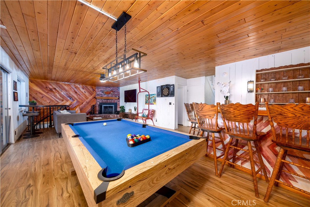 39651 Flicker Road Fawnskin, CA 92333 - Photo 30 of 58 a living room with furniture a rug kitchen view and a table