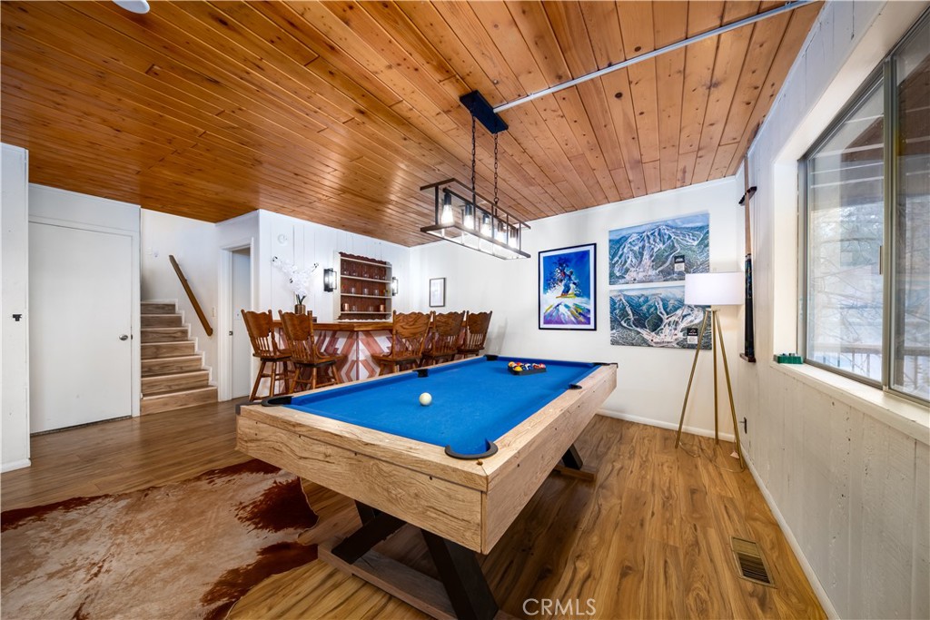 39651 Flicker Road Fawnskin, CA 92333 - Photo 31 of 58 a living room with a dining table tennis pool table and chairs