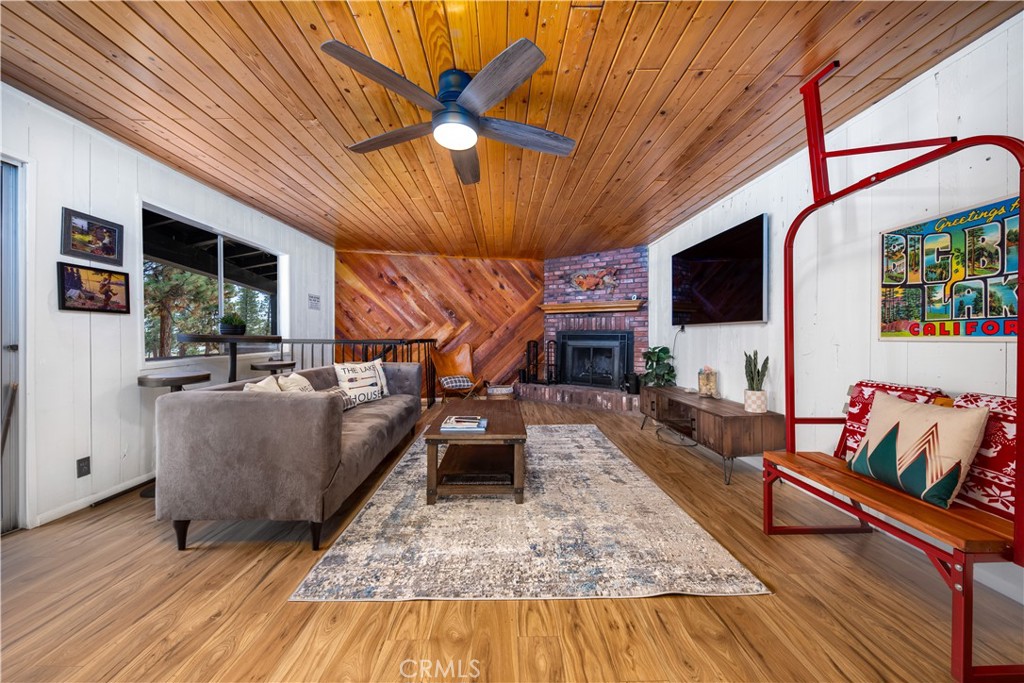 39651 Flicker Road Fawnskin, CA 92333 - Photo 32 of 58 a living room with furniture and a flat screen tv