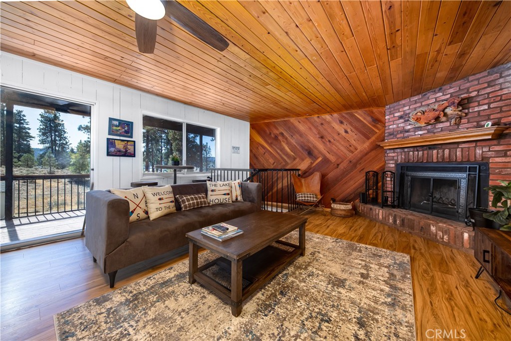 39651 Flicker Road Fawnskin, CA 92333 - Photo 33 of 58 a living room with furniture a fireplace and wooden floor