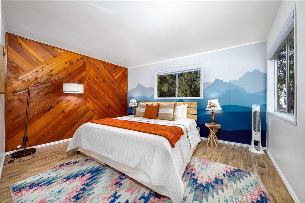 39651 Flicker Road Fawnskin, CA 92333 - Photo 34 of 58 a bed room with a bed and a painting on the wall