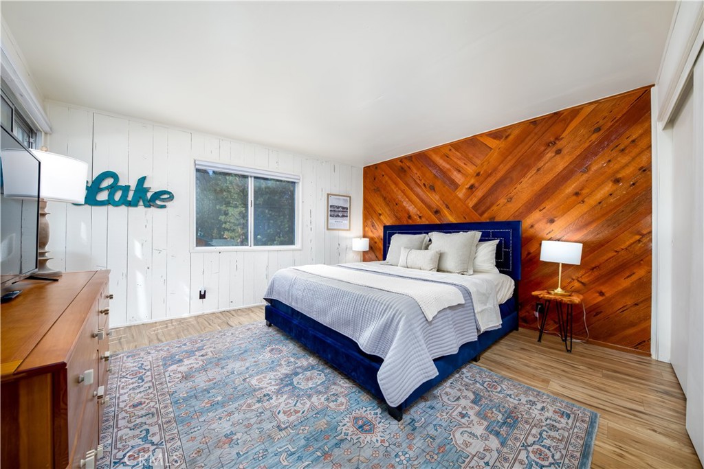 39651 Flicker Road Fawnskin, CA 92333 - Photo 37 of 58 a spacious bedroom with a bed and a window