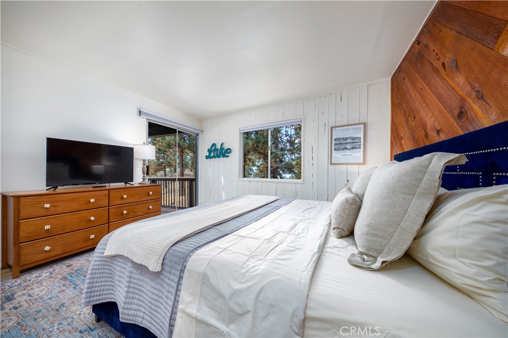 39651 Flicker Road Fawnskin, CA 92333 - Photo 38 of 58 a bedroom with a bed and a television