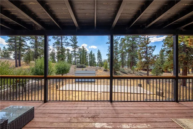 a living room with furniture a flat screen tv and paintings on the wall