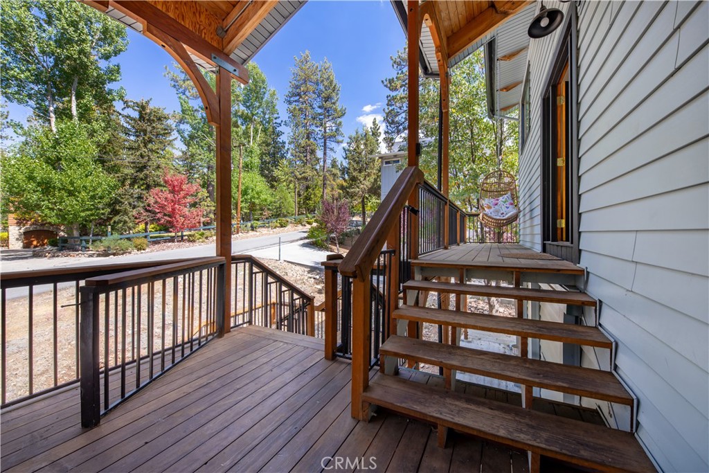 39651 Flicker Road Fawnskin, CA 92333 - Photo 6 of 58 a view of a wooden deck with a bench